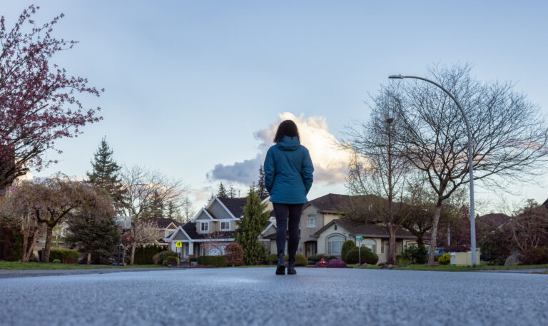 If you are dealing with fighting parents it's important to remove yourself. This photo is an image of a woman taking a walk alone in a neighborhood.